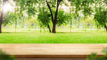 Aufkleber - Empty wood table top with blur park green nature bokeh and leaf foreground,Mock up for display or montage of product,Banner or header for advertise on social media,Spring and Summer background