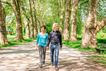 Senior Couple Walking Through A Park