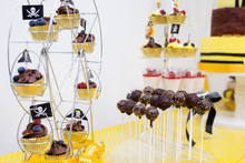 Assortment Of Birthday Party Cakes In Yellow And Black Color, Pirate Theme, For Boy. Focus Cakepops