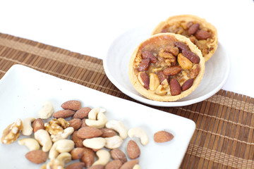 Canvas Print - Mixed nuts and a baked dish tart