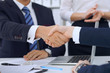 © rogerphoto - Business handshake at meeting or negotiation in the office. Partners are satisfied because signing contract or financial papers