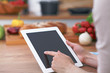 © rogerphoto - Close-up of human hands are gesticulate over a tablet in the kitchen. Women choosing menu or making online shopping. So much ideas for tasty cooking. Vegetarian, healthy meal and friendship concept