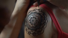 Closeup Video Of Henna Tattoo Artist Draws On Woman's Shoulder - Video In Slow Motion