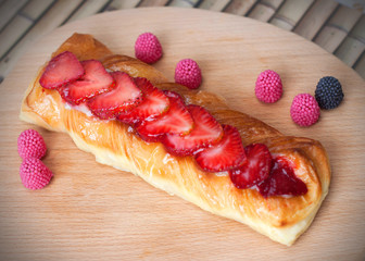 Wall Mural - Dessert with strawberries and berry candies on a wooden board