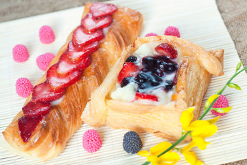 Wall Mural - Pastries with berries on a wooden background. Summer fruit dessert