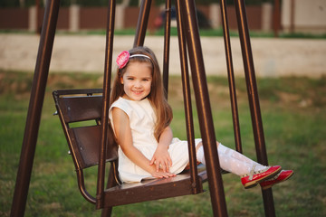 Wall Mural - young happy girl on the swings