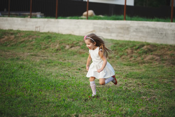 Wall Mural - little beautiful running girl outside