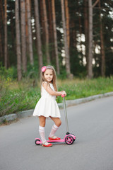 Wall Mural - beautiful girl with scooter on the road