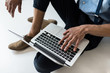 © LIGHTFIELD STUDIOS - Cropped shot of young man using laptop with blank screen on grey