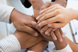 © 88studio - young businessman joining hand, business team touching hands together - unity, harmony, teamwork, partnership, collaboration, corporate concept.