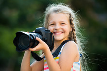 Little Girl With Camera Outdoors.
