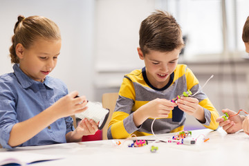 Wall Mural - happy children building robots at robotics school