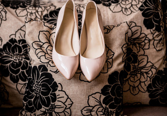 Beige bride shoes on the pillow