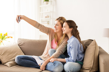 Canvas Print - happy family taking selfie by smartphone at home