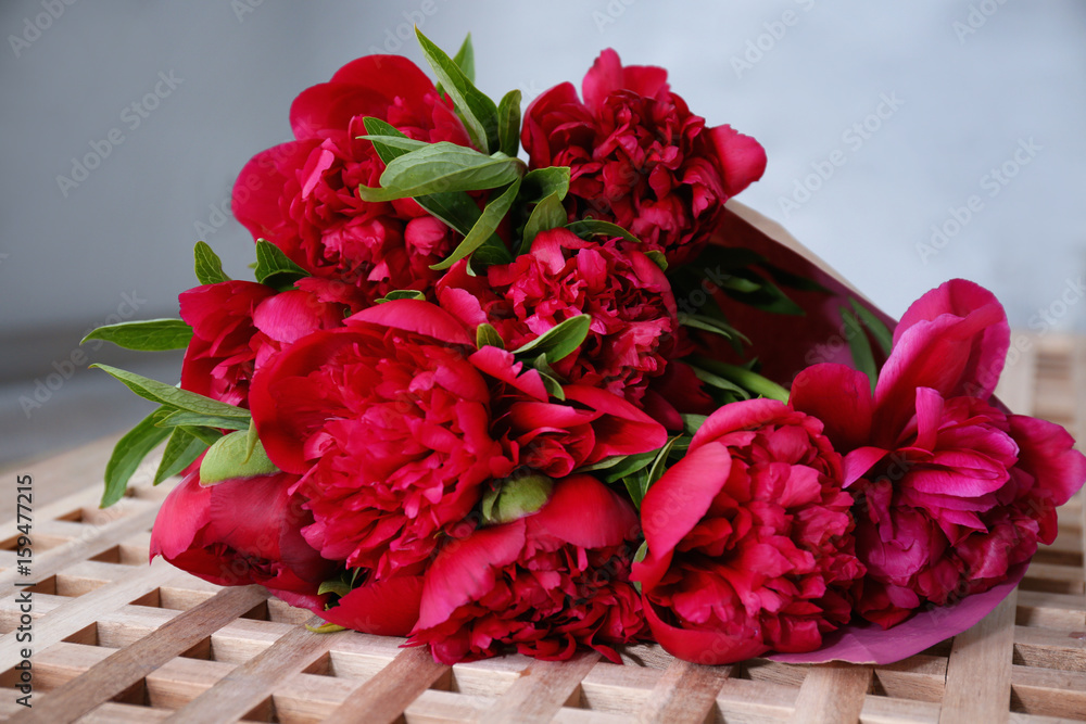 Beautiful bouquet of fresh peonies on table