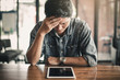 © Sirichai - Portrait of an upset businessman at desk in office. Businessman being depressed by working in office.Strain,Yong business man to think and not Work with stress Pretending to put his hand to the head.