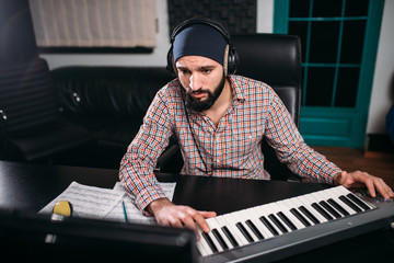 Sound producer in headphones work in studio