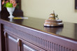 © sharafmaksumov - Service bell in a hotel reception for concierge alarm on desk.