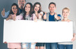 © shefkate - Happy group of people of different professions holding a blank billboard.