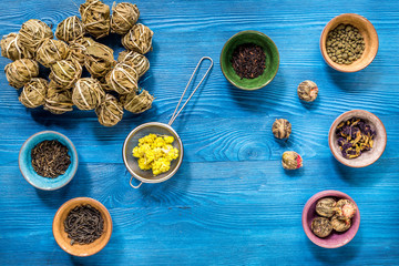 Wall Mural - Tea-party with different herbal tea on blue desk background flat lay mock up