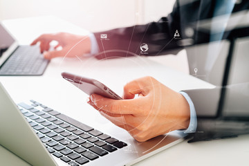 Poster - Hands of businessman using mobile phone in modern office with laptop and digital tablet computer with VR icon diagram