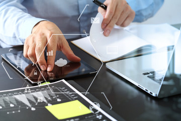Poster - close up of businessman working with smart phone and digital tablet and laptop computer  on wooden desk in modern office with virtual icon diagram