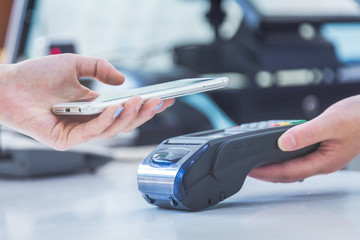 Close up of mobile payment in a shop.