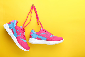 Wall Mural - Sport shoes on yellow background