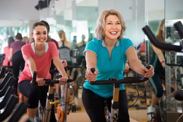 vigorous females of different age training on exercise bikes