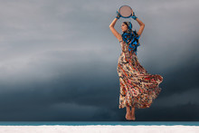 Attractive Young Woman With Tambourine Outdoors. One Minute Before Storm