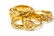 Group of many design gold rings on white background