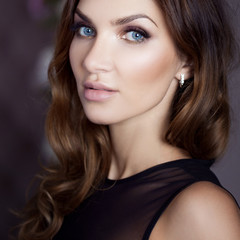 Beautiful sexy brunette with blue eyes. Portrait in the Studio, on the background of the mirror in beautiful frame