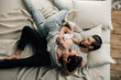 © LIGHTFIELD STUDIOS - Top view of sensual young couple of lovers lying and hugging on bed