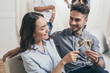 © LIGHTFIELD STUDIOS - young couple clinking with champagne glasses at home party