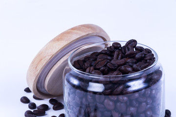 Wall Mural - Coffee beans in the jar on dark wood background