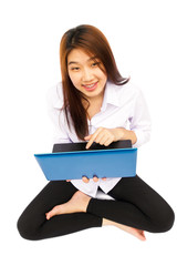 Young Asian girl playing a laptop on white background