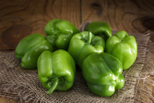 A Few Fresh Green Peppers On Burlap On A Wooden Table.  Fresh Green Peppers Variety Dolma. Low Key, Close-up.