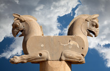 Homa The Griffin Capital Statuary In Persepolis Of Shiraz In Iran Against Blue Sky With White Fluffy Clouds