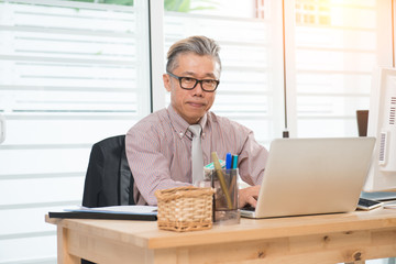 senior asian male at work