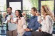 © LIGHTFIELD STUDIOS - Smiling middle aged businessmen and businesswomen eating asian food in office