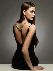 Wall Mural - beautiful young woman in sexy dress and jewelry