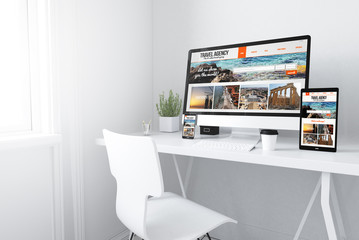  devices on white minimal workspace travel agency website