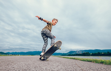 Boy makes a trick with skateboard