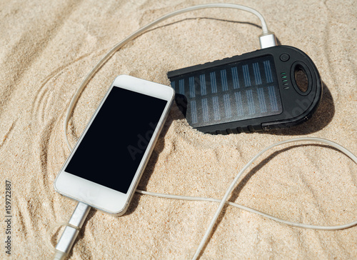 Battery Solar Energy Device On A Background Of The Sandy