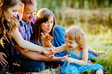 Sticker - happy family with two children having fun in lake shore on a summer day in sunset. two sisters playi