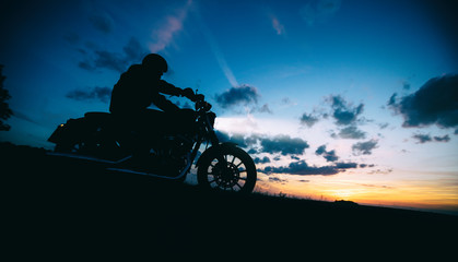 Wall Mural - Dark motorbiker silhouette riding high power motorbike