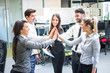 © Bojan - Business people gathering hands in unity celebrating team spirit.