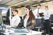 © Bojan - Smiling agent woman with headsets helping a customer. Portrait of call center worker at office.