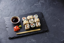 Sushi Rolls Yin Yang Shape On Stone Slate On Black Stone Background Copy Space