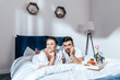 © LIGHTFIELD STUDIOS - Happy couple in love having breakfast in bed